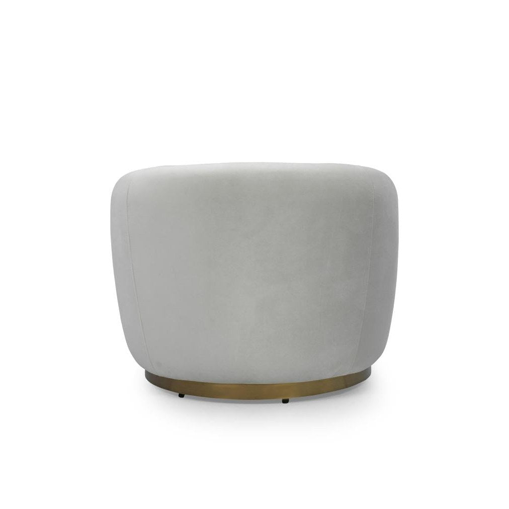 Front view of the Sumi Accent Chair in champagne velvet with a recessed circular gold swivel base