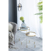 Gold rimmed side tables styled with flowers in a minimalist room