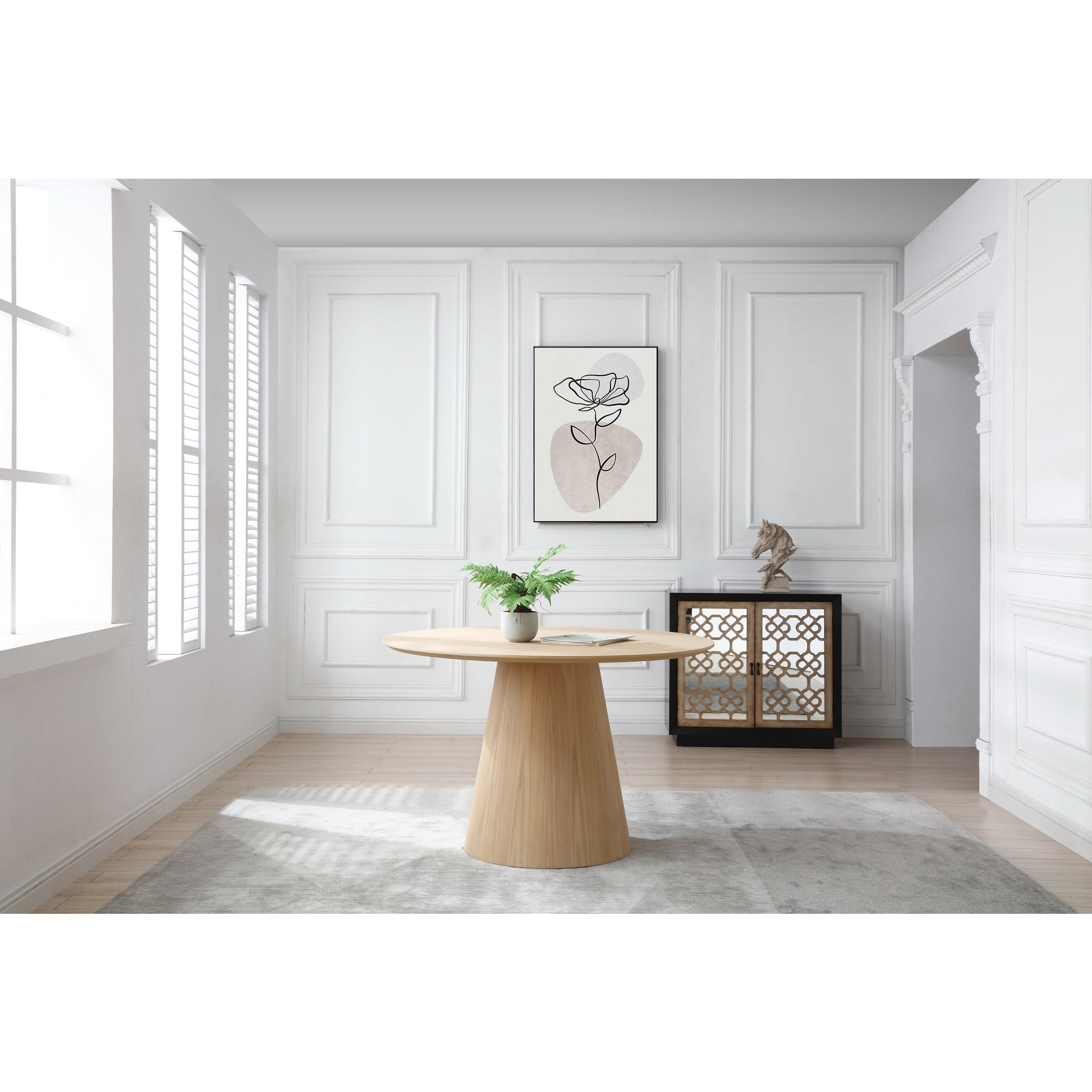 Three-quarter perspective view highlighting the clean architectural lines and smooth circular top of the oak dining table