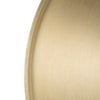 Close up detail of brushed gold metal finish on round side table top