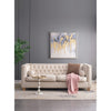 Villa gold and marble side table styled next to a tufted cream sofa