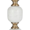 Detailed view of white marble orbs and gold spacers on table pedestal